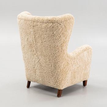 A variation of model 1672 new sheepskin upholstered lounge chair from Fritz Hansen.
