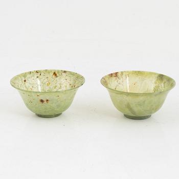 A pair of Chinese green stone bowls.