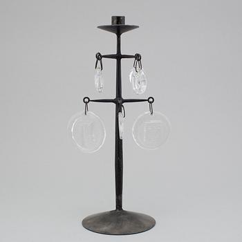 an iron and glass candlestick.