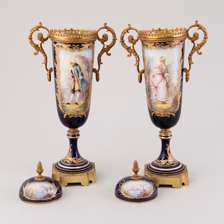Pair of Sevres Chateau des Tuileries porcelain lidded urns, mid-19th century.