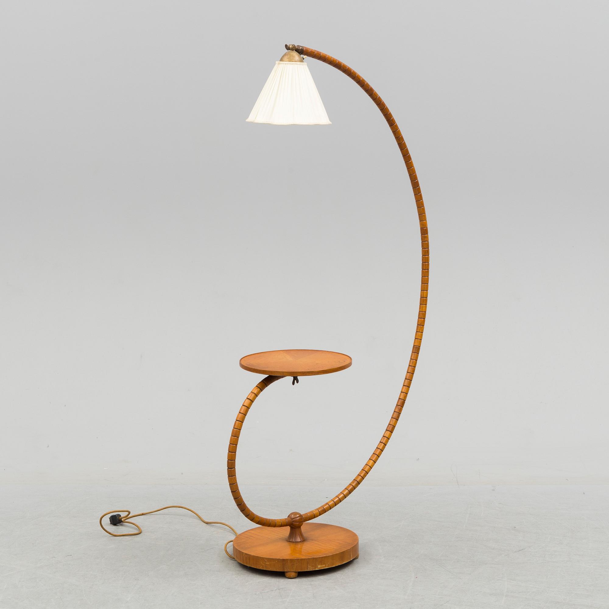 A first half of the 20th century floor lamp with table.