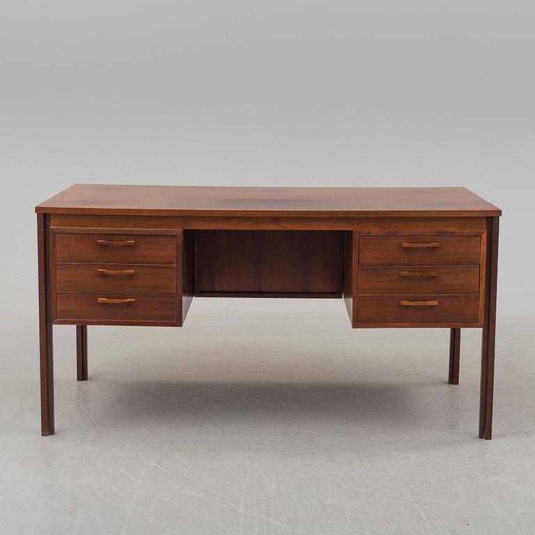 A 1960's/1970's rosewood veneered desk.