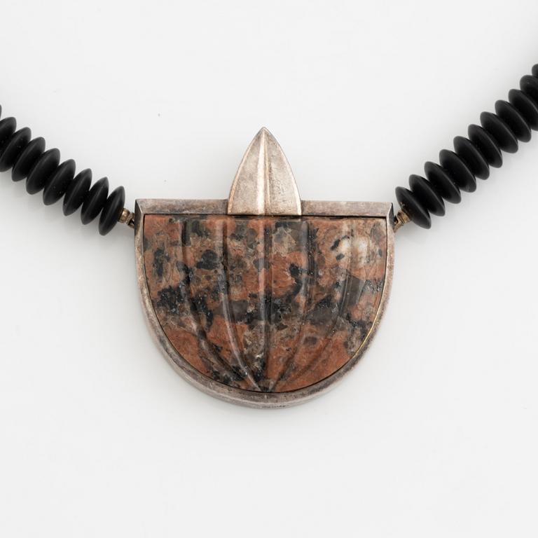 Gaudy necklace, silver and carved stone.