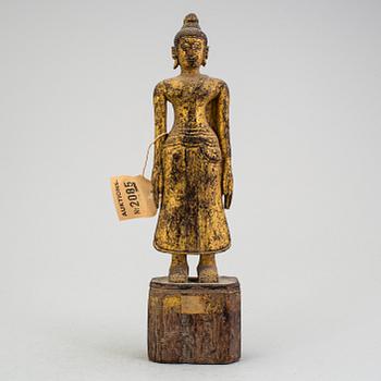 A Burmese sculpture of a standing buddha, circa 1900.