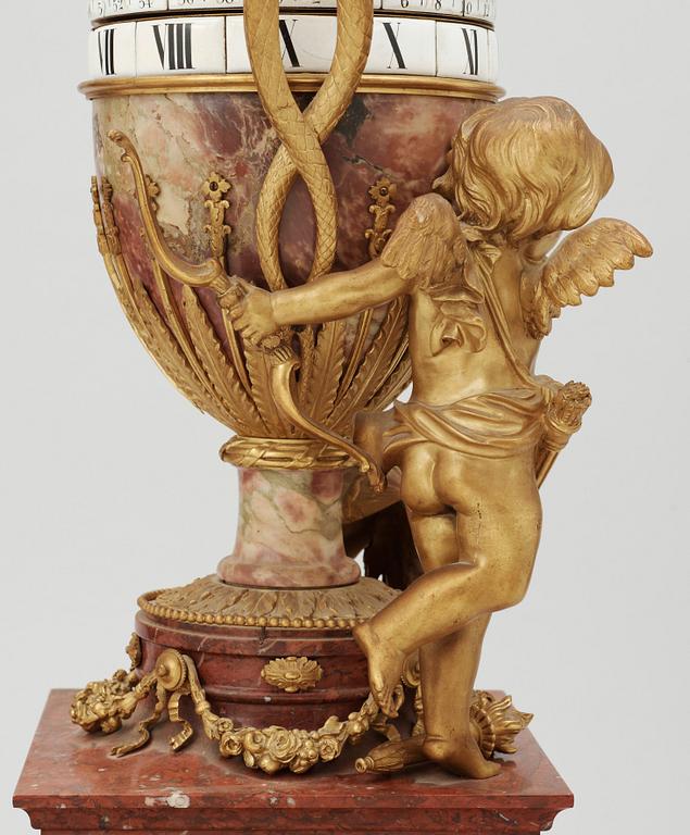 A Louis XVI-style late 19th century gilt bronze and marble vase clock "Pendule à cercles tournants", Dufaud Paris.