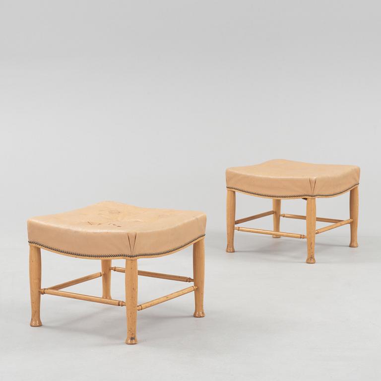 A pair of Josef Frank mahogany and beige leather stools, Svenskt Tenn, model 902.