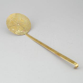 An 18th century brass strainer.