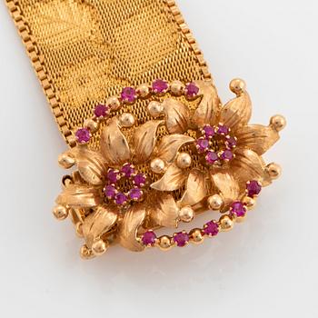 An 18K gold bracelet set with rubies.
