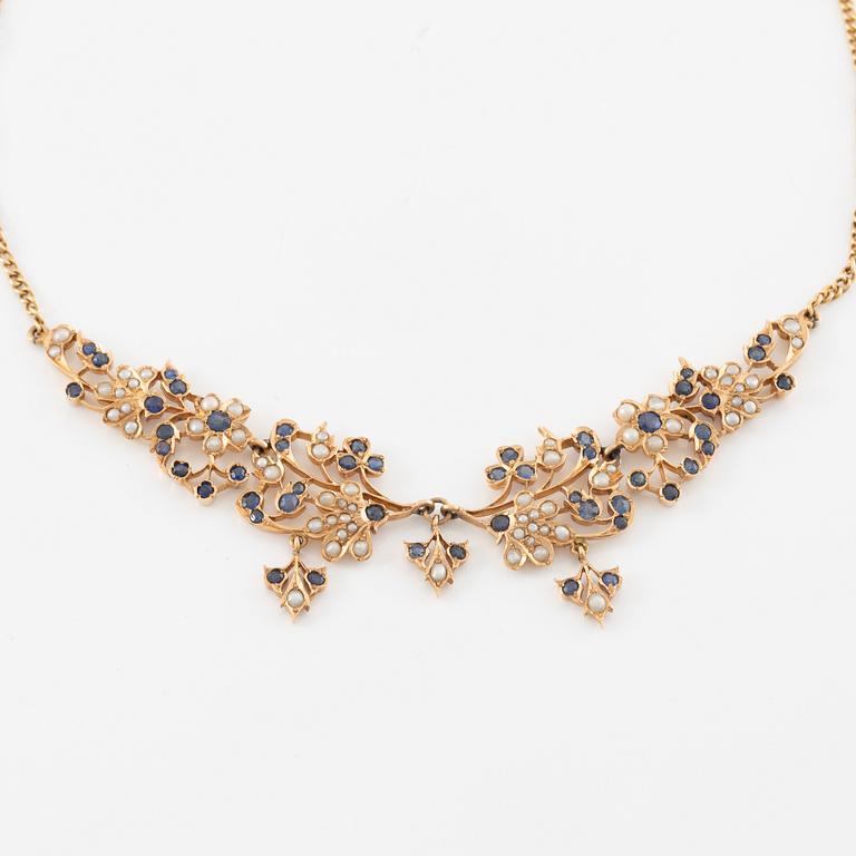 A 14K gold necklace with sapphires and pearls.