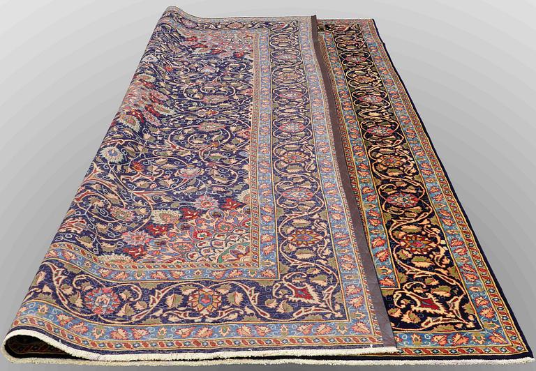 A carpet, Kashmar, signed, ca 390 x 295 cm.