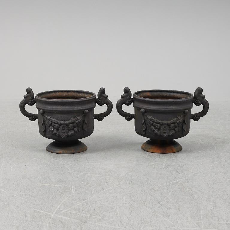 A 20th Century pair of cast iron flower pots.