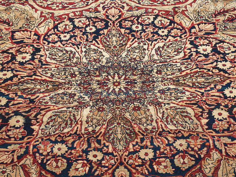 A carpet, an antique Kerman Laver, ca 677-688,5 x 510,5-526 cm.