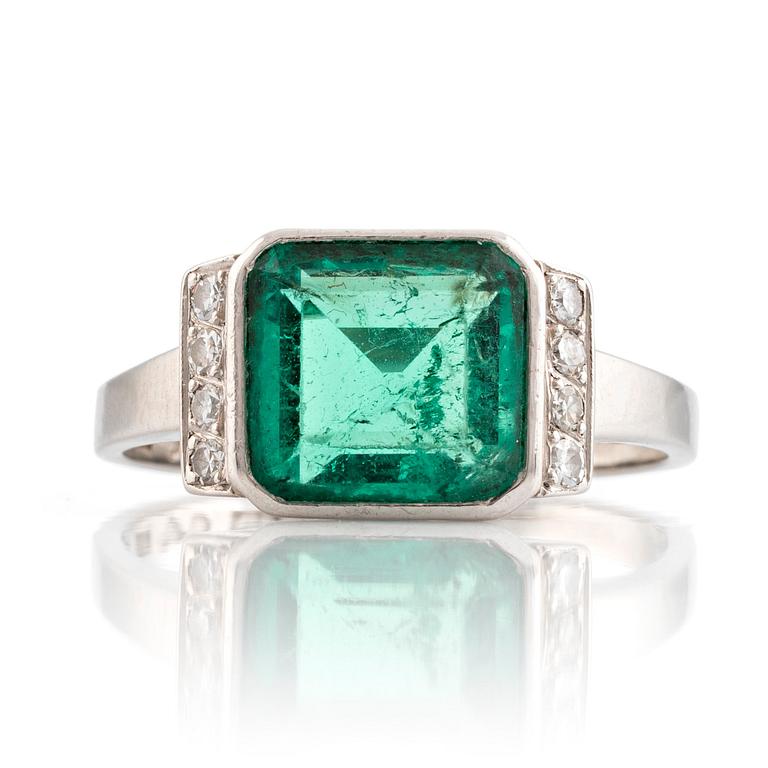 Platinum and emerald and eight cut diamond ring.