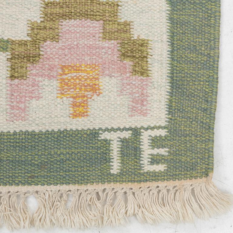 A flat weave carpet, signed TE, c. 224 x 126 cm.