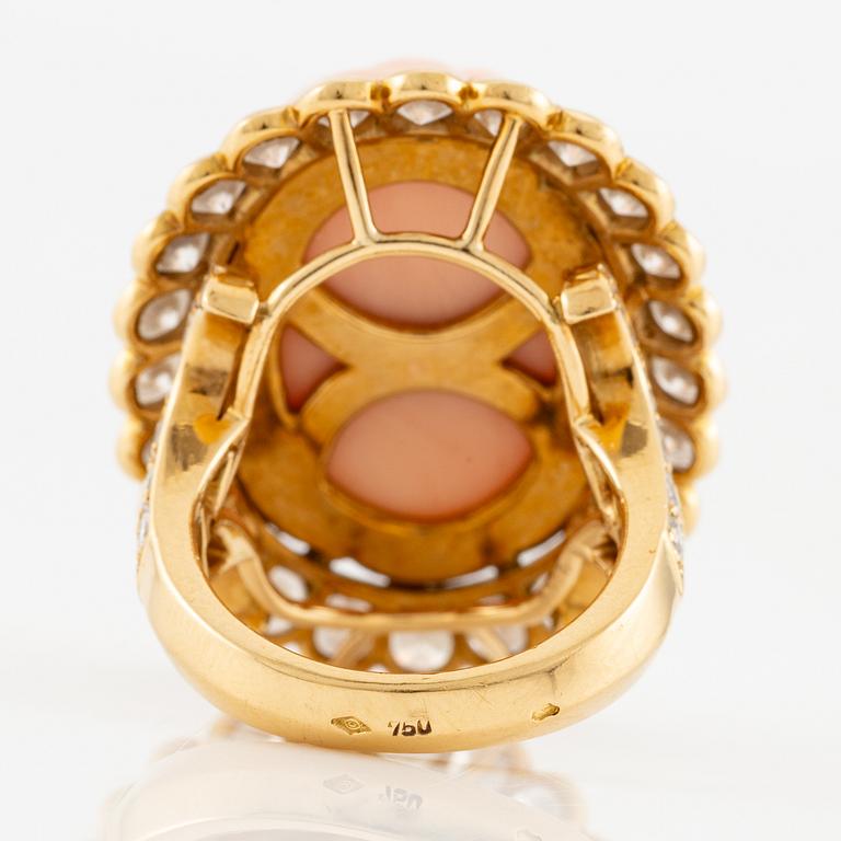 An 18K gold and coral Cartier ring set with round brilliant-cut diamonds.