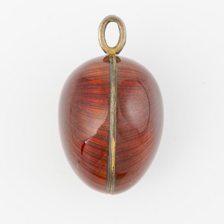 Pendant in the shape of an egg, silver with red enamel.