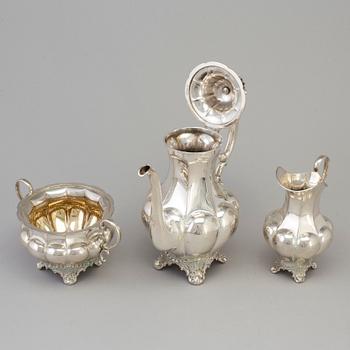 A three piece silver coffee set dated 1916-17.
