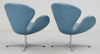 A pair of Arne Jacobsen blue leather "Swan" easy chairs, Fritz Hansen, Denmark 1990.