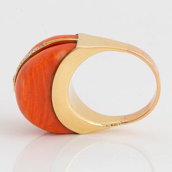 An 18K gold and coral ring set with eight-cut diamonds.