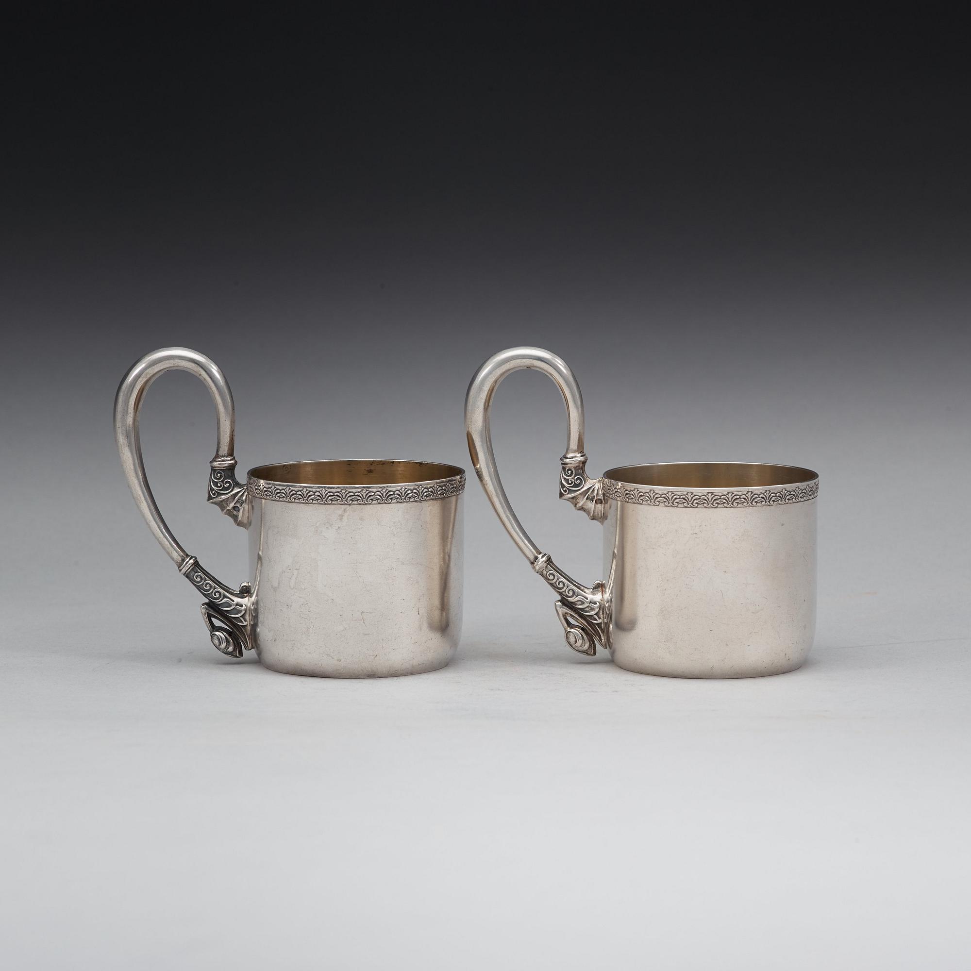 A pair of Russian 20th century parcel-gilt tea-glas holders, marks possibly of Vasily Andreyev, Moscow 1908-1917.