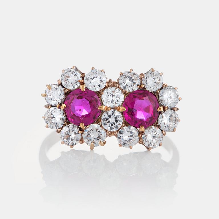 A 14K gold ring set with two faceted rubies ca 0.85 cts and round brilliant-cut diamonds.