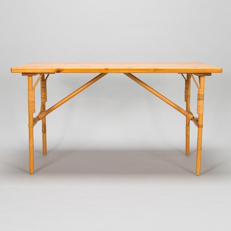 A pine wood and rattan table, late 20th century.