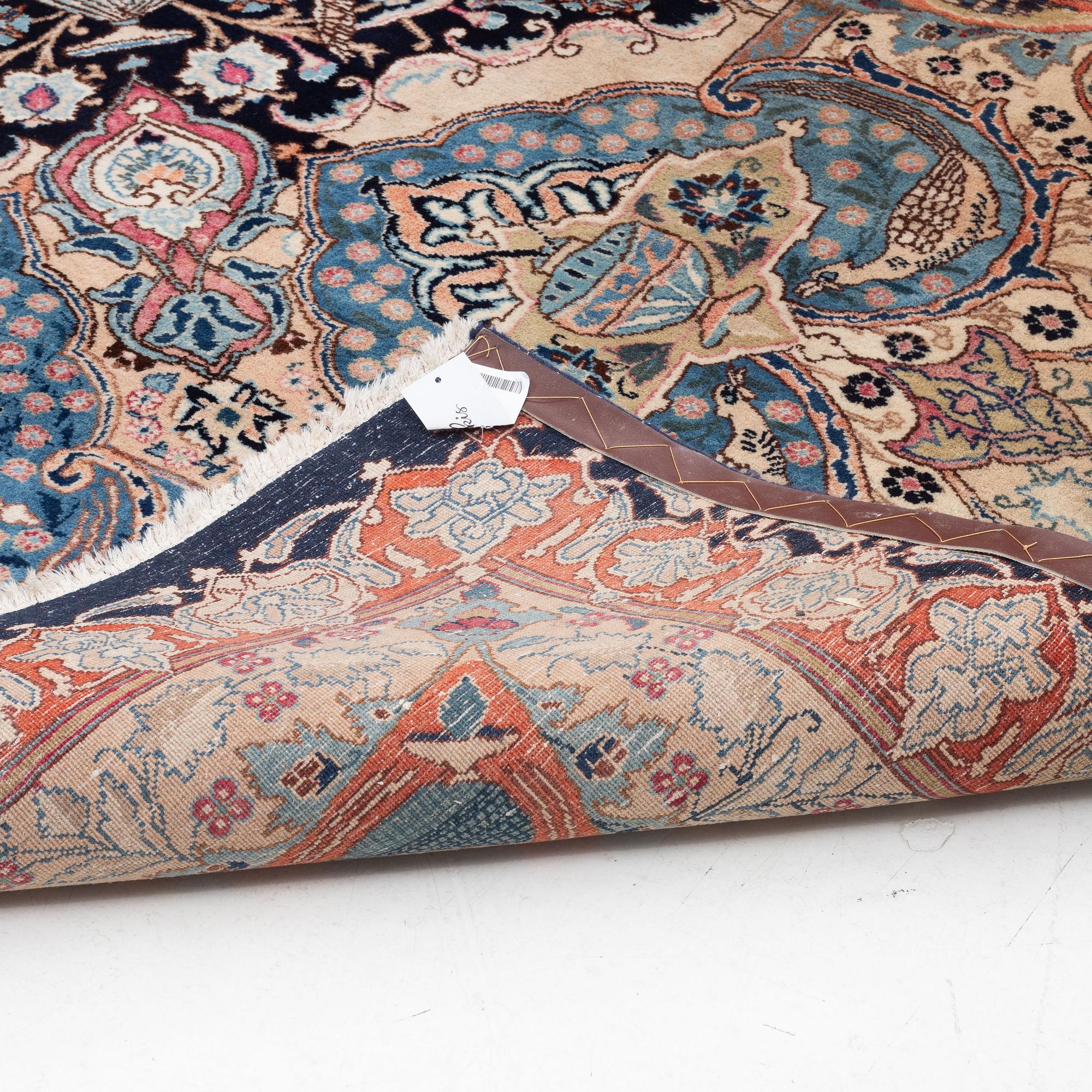 An oriental carpet, circa 390 x 302 cm.