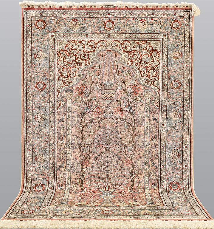 A figural Oriental silk carpet, approx. 155 x 93 cm.