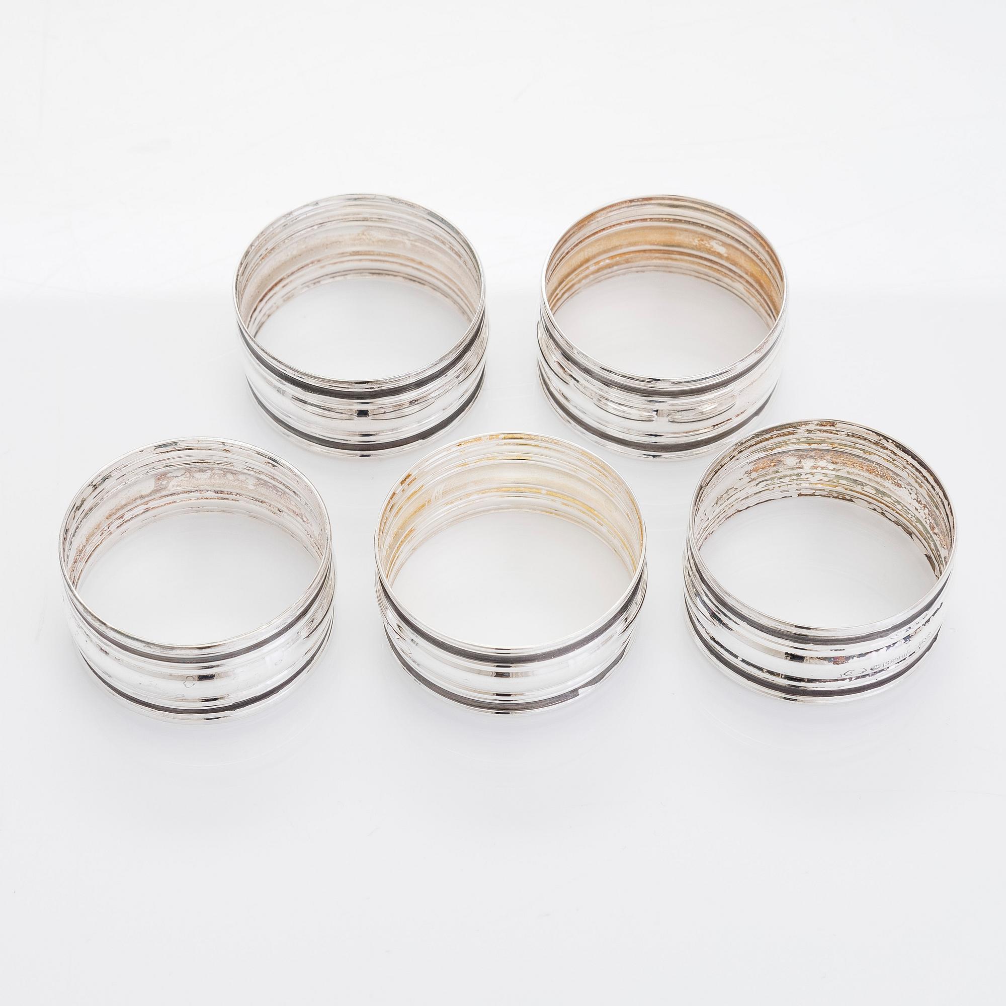 A set of six vodka cups, five napkin rings, a champagne whisk, and a tong, silver, Turku and Hämeenlinna, 1938, 1970.