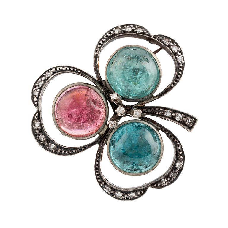 A silver and 18K gold brooch set with cabochon-cut tourmalines.