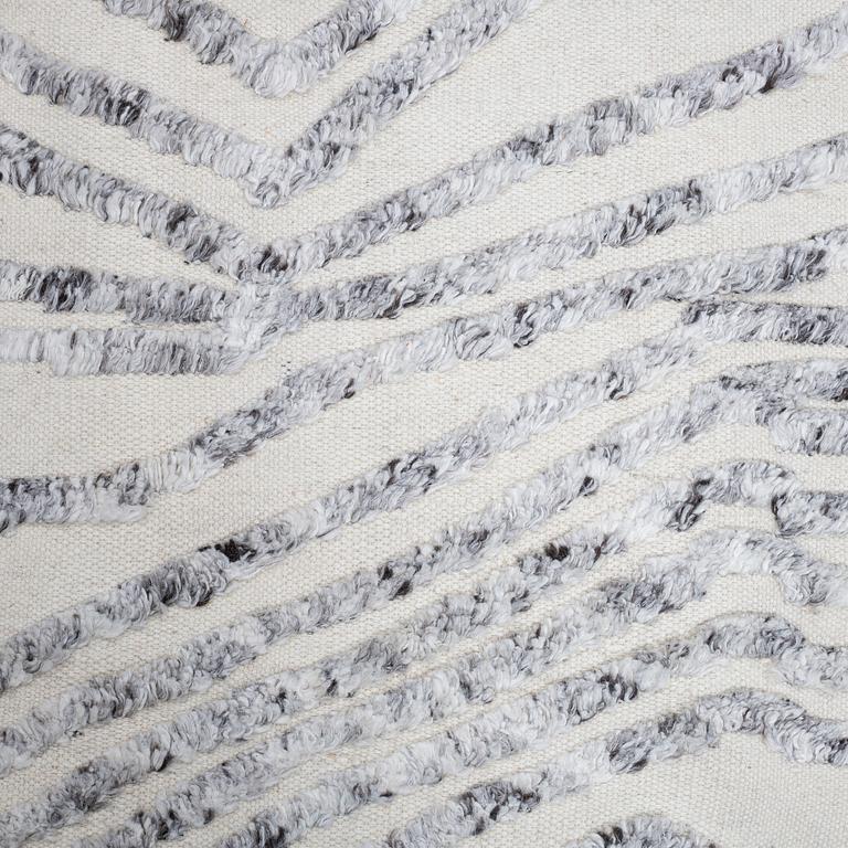 A CARPET, flat weave, with knoted detalis in relief, ca 300 x 240 cm.