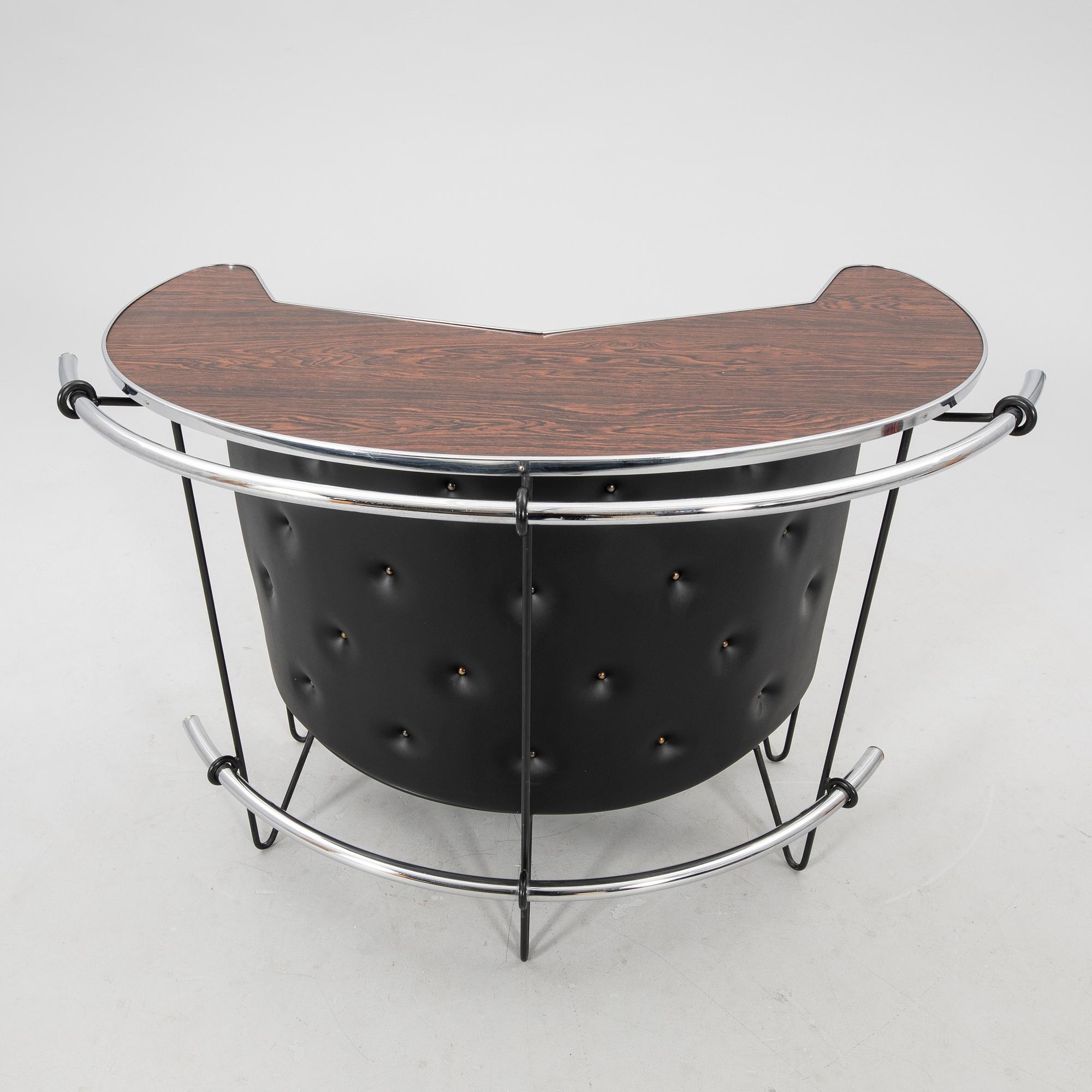 A 1970s bar and four stools.