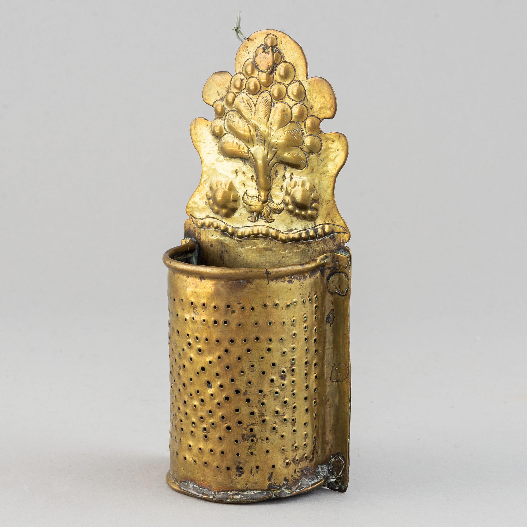 A 17th century brass spoon holder.