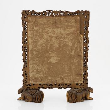 A Chinese wood mirror, 20th century.