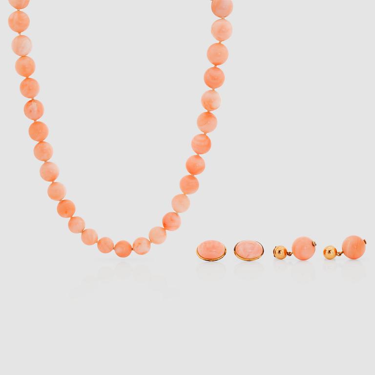 An 'Angel skin' coral necklace. 8.4 - 12.4 mm in diameter and a pair of matching earrings.