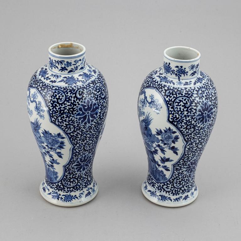 A pair of blue and white vases, Qing dynasty, late 19th century, with a Kangxi mark to the base.