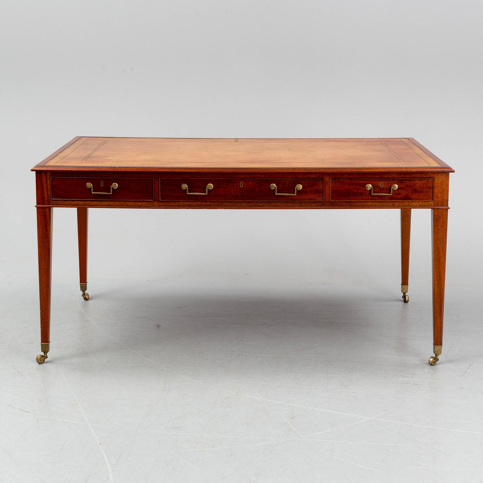 A contemporary mahogany and leather partners desk in the George III style.