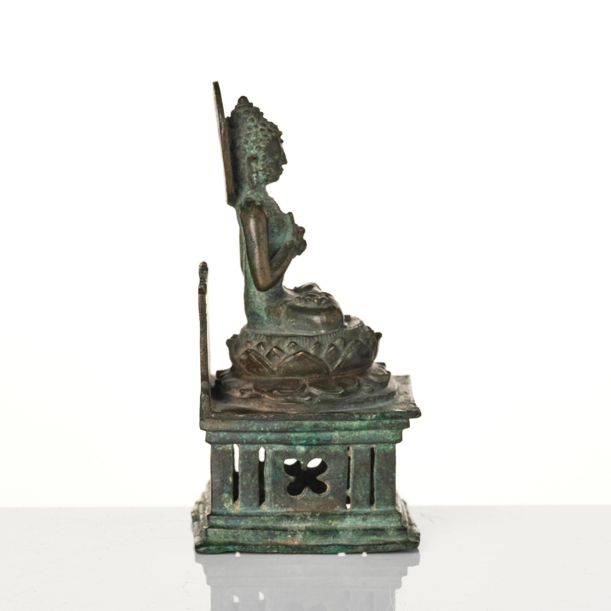 A bronze Buddha Vairocana, Eastern Java, 10th century.