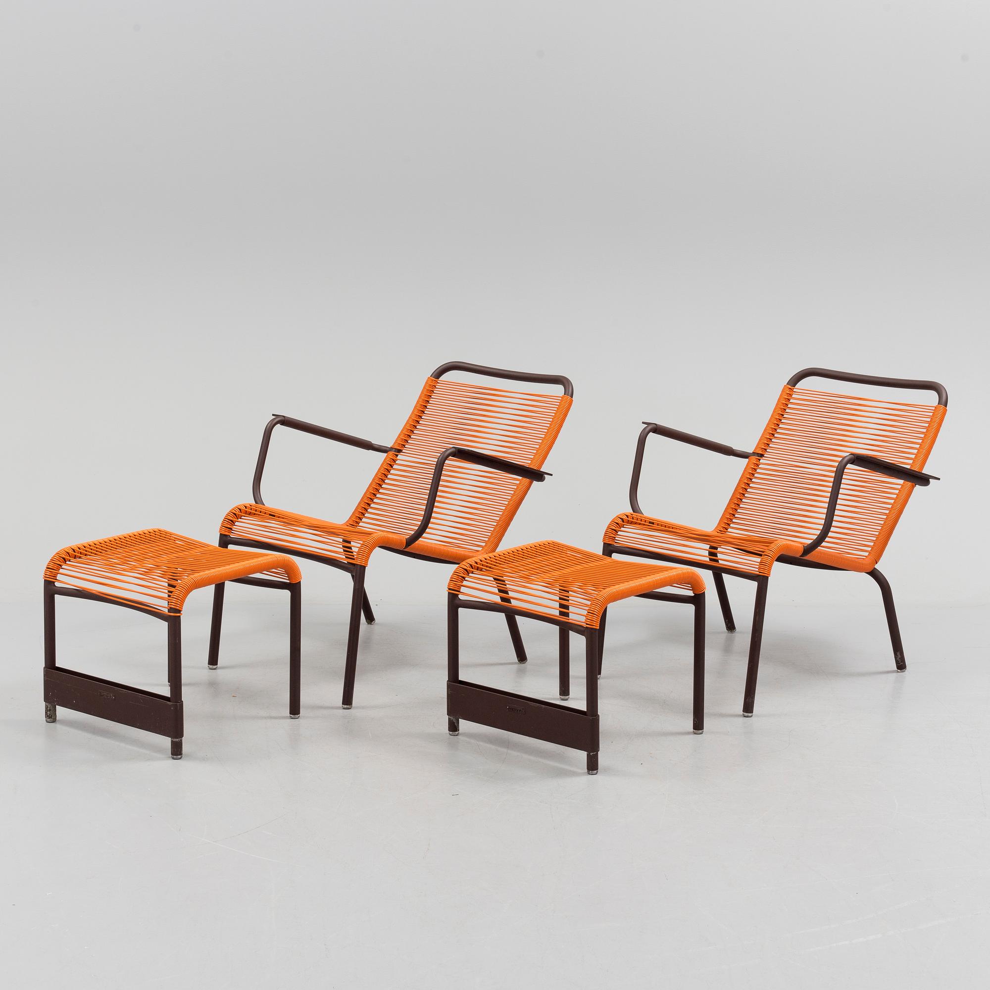 a pair of FRÉDÉRIC SOFIA "Saint Tropez" lounge chairs with footstools, by Fermob.