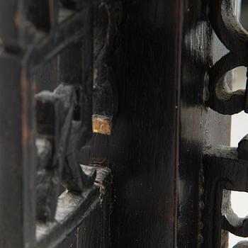 A Chinese carved wood floor lamp from the first half of the 20th Century.