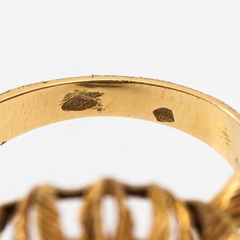 An 18K gold ring with a ruby.