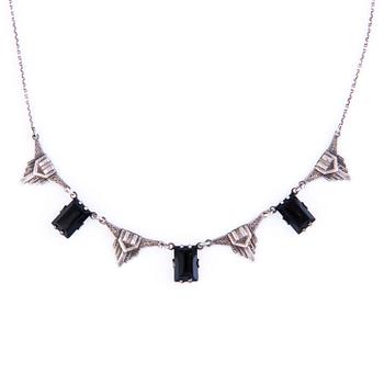 Four Art deco jewelry, ring, pendant necklace and earrings in silver.