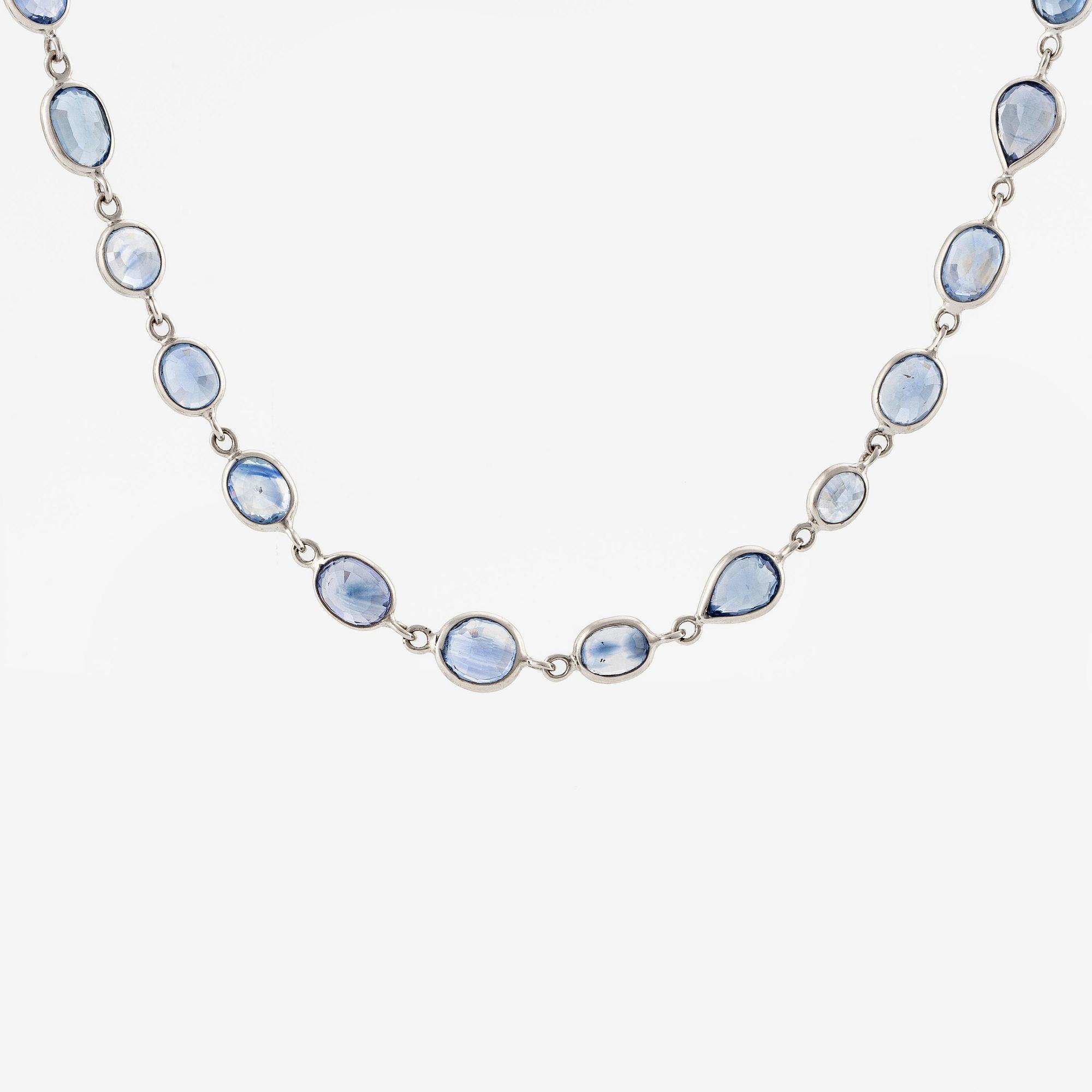 An 18K white gold necklace set  with faceted sapphires.