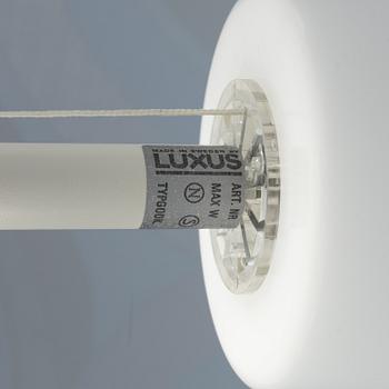 A white metal floor light, Luxus, Vittsjö.