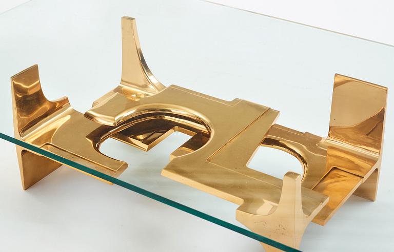 Gerard Mannoni, a polished bronze and glass sofa table, France 1974.