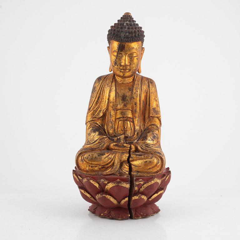 A gilt and lacquered figure of a seated buddha, late Qing dynasty.
