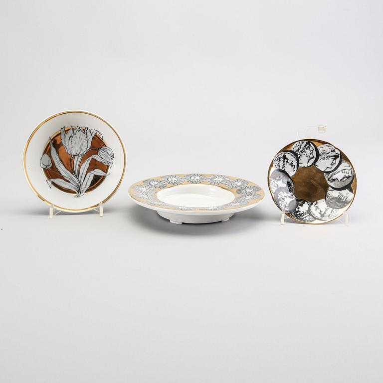 A st of three Piero Fornasetti porcelain plates.