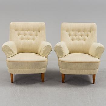 A pair of second half of the 20th century 'Hemmakväll' easy chairs by Carl Malmsten.