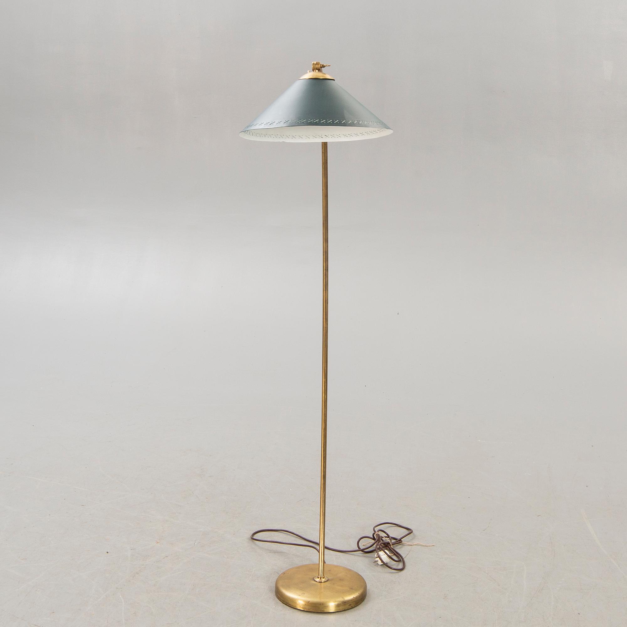 A 1950s brass floor lamp.