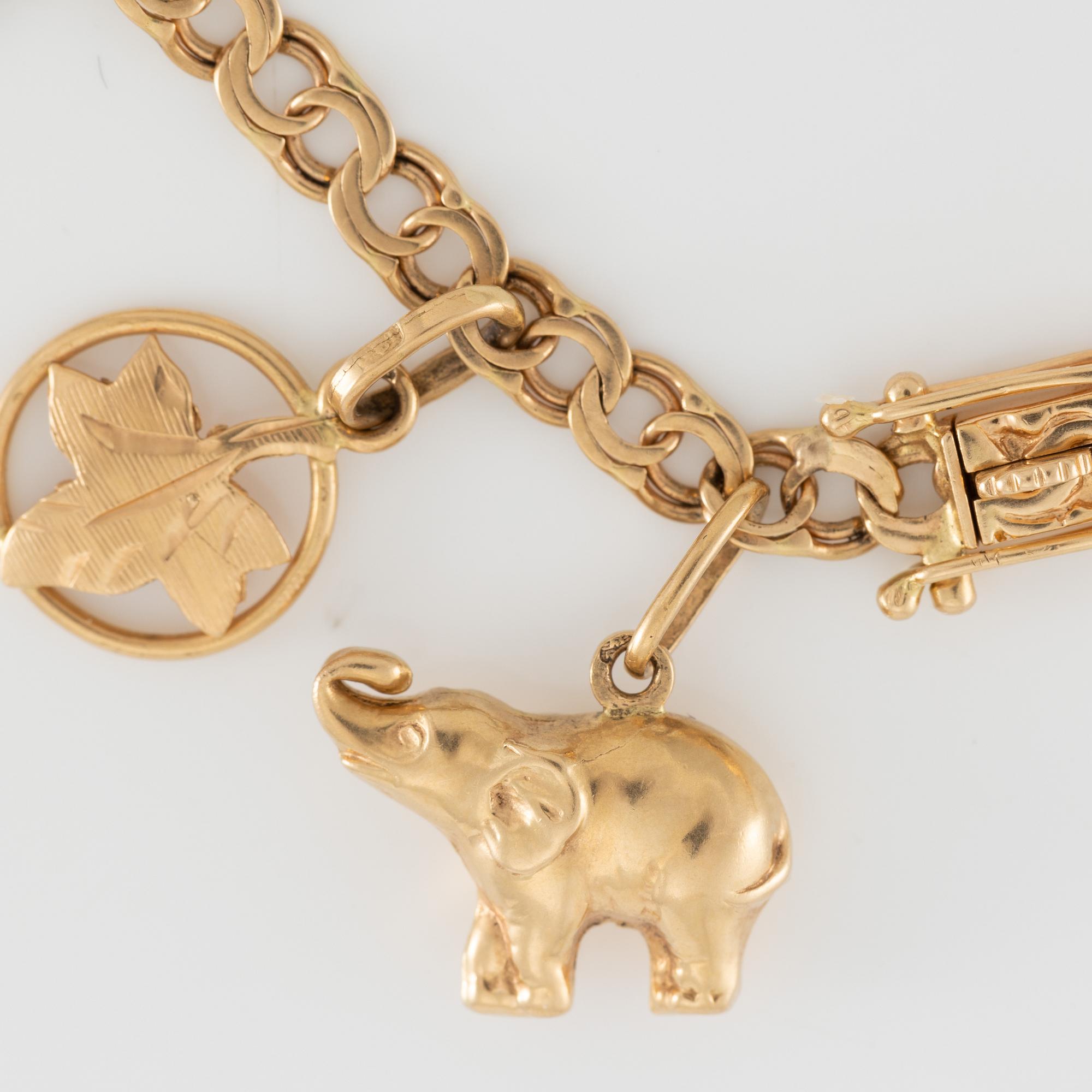 Armband 18K guld med berlocker.